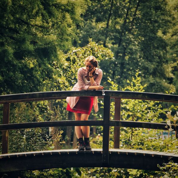 woman standing on bridge