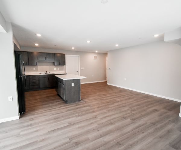 couple cooking in open concept kitchen in Ursa apartments